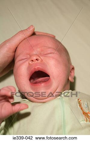 Calming a crying baby View Large Photo Image Stock Image - Calming a crying baby. Fotosearch