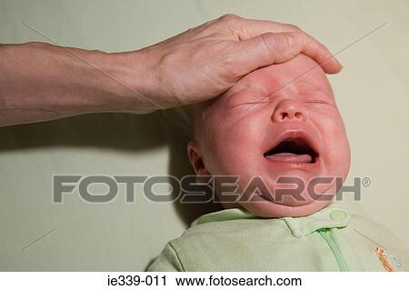 Person comforting crying baby View Large Photo Image Stock Image - Person comforting crying baby. Fotosearch