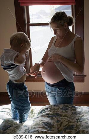 Pregnant mother with son View Large Photo Image Stock Photograph - Pregnant mother with son. Fotosearch