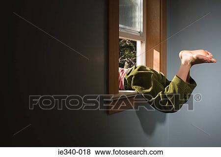 Boy climbing out of window View Large Photo Image Stock Photo - Boy climbing out of window. Fotosearch