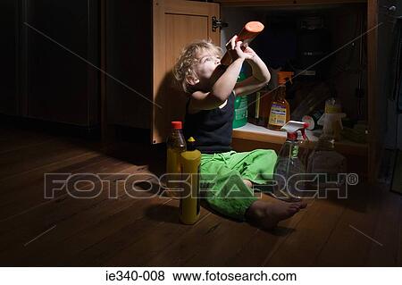 Boy drinking cleaning product View Large Photo Image Stock Photo - Boy drinking cleaning product. Fotosearch