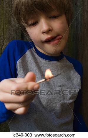 Boy playing with fire View Large Photo Image Stock Image - Boy playing with fire. Fotosearch