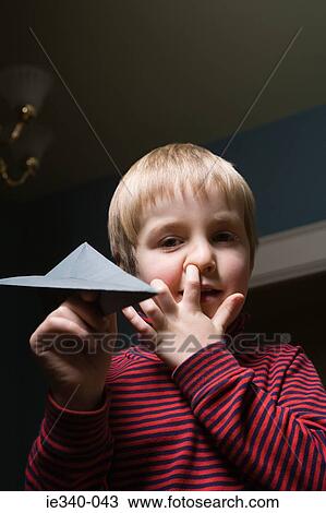 Boy with paper airplane View Large Photo Image Stock Image - Boy with paper airplane. Fotosearch