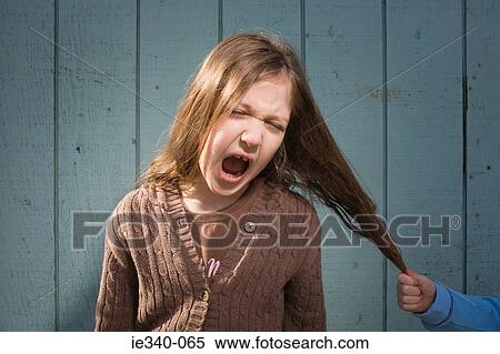 Girl having hair pulled View Large Photo Image Stock Photography - Girl having hair pulled. Fotosearch