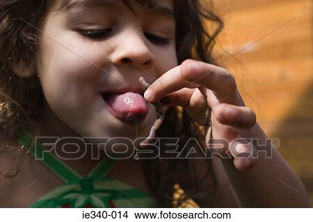 Girl trying to eat worm View Large Photo Image Picture - Girl trying to eat worm. Fotosearch