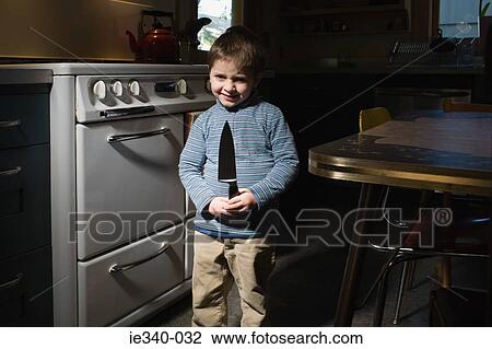 Stock Image - Little boy with knife. Fotosearch