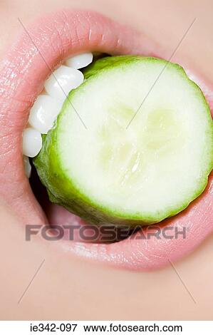 Cucumber slice in womans mouth View Large Photo Image Stock Photo - Cucumber slice in womans mouth. Fotosearch