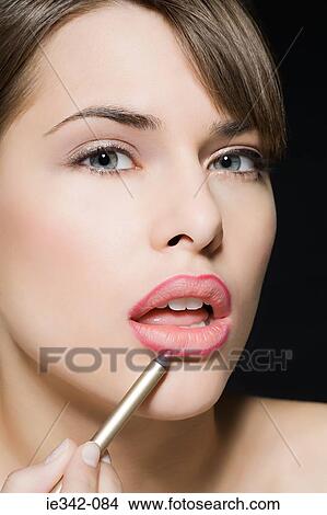 Picture - Woman applying lip liner. Fotosearch