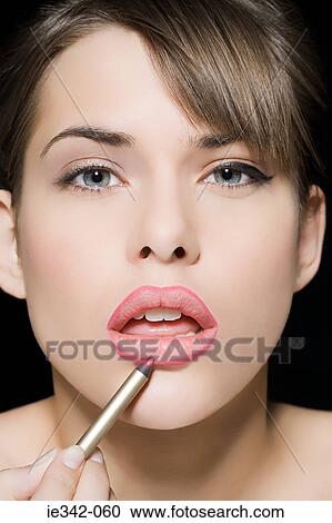 Woman applying lip liner View Large Photo Image Stock Image - Woman applying lip liner. Fotosearch