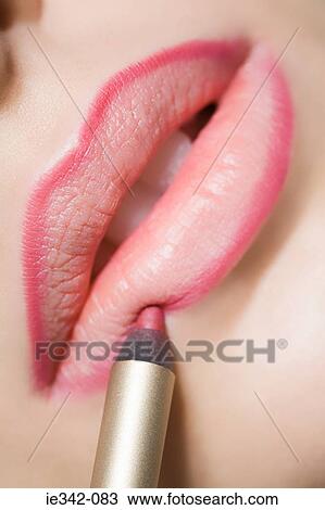 Stock Image - Woman applying lip liner. Fotosearch