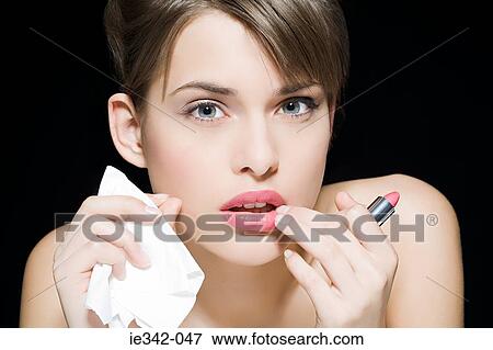 Woman applying lipstick View Large Photo Image Stock Photo - Woman applying lipstick. Fotosearch