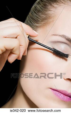 Woman applying mascara View Large Photo Image Stock Image - Woman applying mascara. Fotosearch