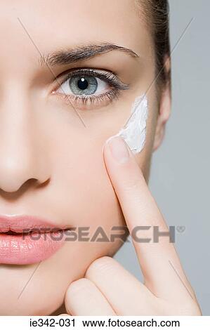 Woman applying moisturiser View Large Photo Image Stock Image - Woman applying moisturiser. Fotosearch