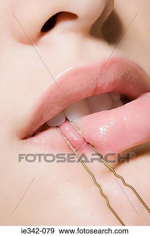 Woman biting hair pin View Large Photo Image Stock Photo - Woman biting hair pin. Fotosearch