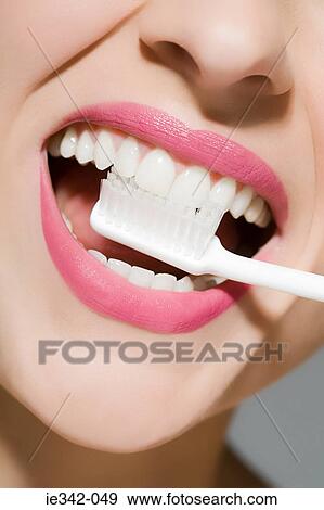 Woman brushing teeth View Large Photo Image Stock Photo - Woman brushing teeth. Fotosearch