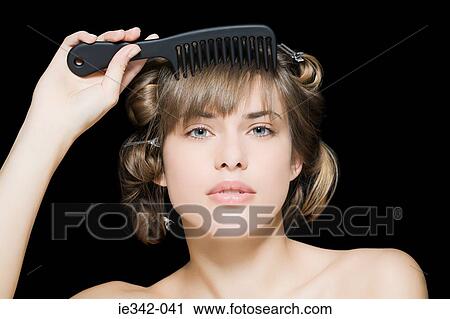 Woman combing hair View Large Photo Image Stock Image - Woman combing hair. Fotosearch