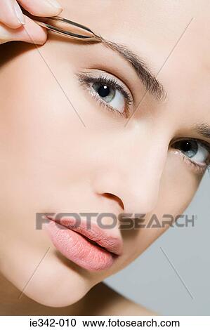 Woman plucking eyebrow View Large Photo Image Stock Image - Woman plucking eyebrow. Fotosearch