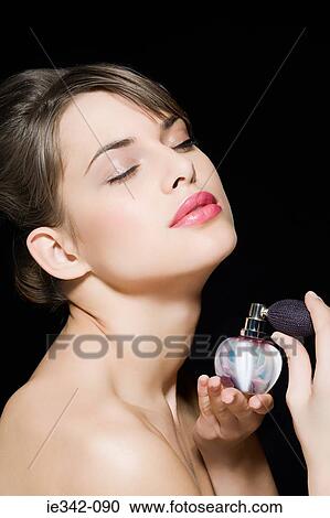 Woman spraying perfume View Large Photo Image Stock Image - Woman spraying perfume. Fotosearch