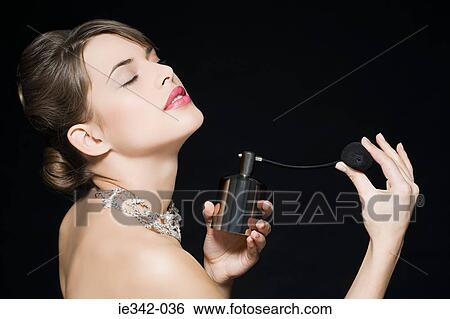 Stock Photograph - Woman spraying perfume. Fotosearch