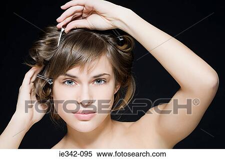 Woman styling her hair View Large Photo Image Stock Photography - Woman styling her hair. Fotosearch