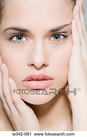 Stock Image - Woman touching face. Fotosearch