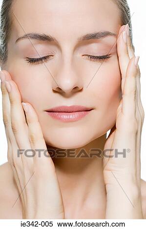 Woman touching face View Large Photo Image Stock Photography - Woman touching face. Fotosearch