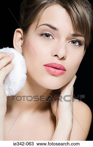 Woman using powder puff View Large Photo Image Stock Image - Woman using powder puff. Fotosearch