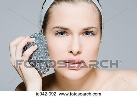Woman using scouring pad on her face View Large Photo Image Stock Image - Woman using scouring pad on her face. Fotosearch