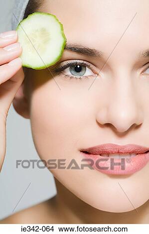 Woman with cucumber slice View Large Photo Image Picture - Woman with cucumber slice. Fotosearch