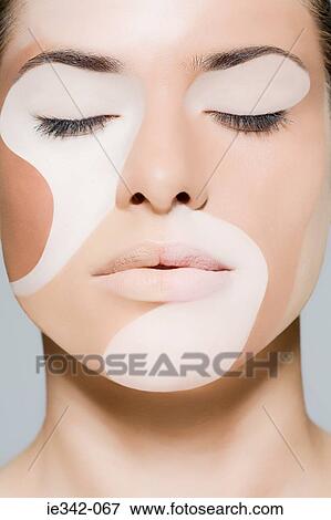 Woman with different colours on her face View Large Photo Image Stock Photo - Woman with different colours on her face. Fotosearch