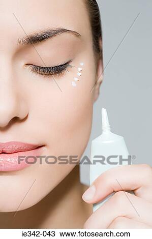Woman with eye cream View Large Photo Image Stock Image - Woman with eye cream. Fotosearch