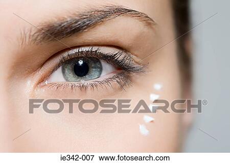 Woman with eye cream View Large Photo Image Stock Photo - Woman with eye cream. Fotosearch