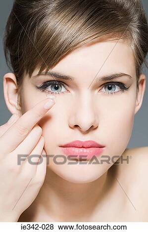 Young woman with contacts lens View Large Photo Image Stock Photo - Young woman with contacts lens. Fotosearch