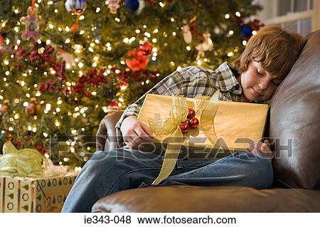 Boy with a christmas gift View Large Photo Image Stock Photo - Boy with a christmas gift. Fotosearch