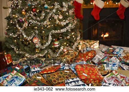 Christmas gifts by tree View Large Photo Image Stock Image - Christmas gifts by tree. Fotosearch