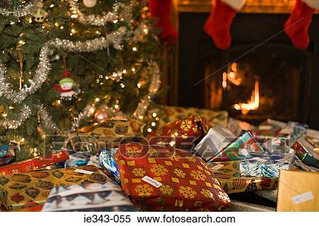Christmas gifts by tree View Large Photo Image Stock Photography - Christmas gifts by tree. Fotosearch