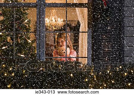 Girl looking at snow View Large Photo Image Stock Image - Girl looking at snow. Fotosearch