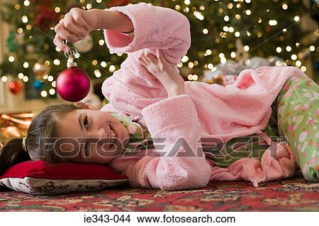 Girl with a christmas bauble View Large Photo Image Picture - Girl with a christmas bauble. Fotosearch