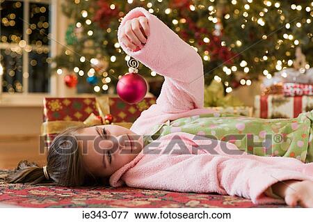 Stock Photo - Girl with a christmas bauble. Fotosearch