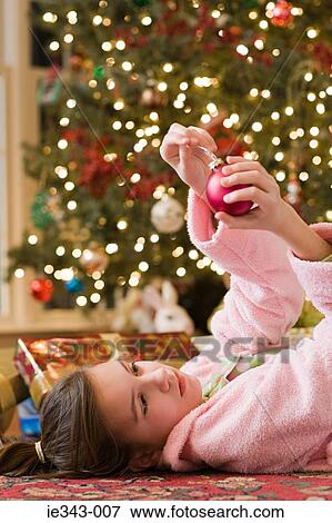 Girl with christmas bauble View Large Photo Image Stock Photo - Girl with christmas bauble. Fotosearch