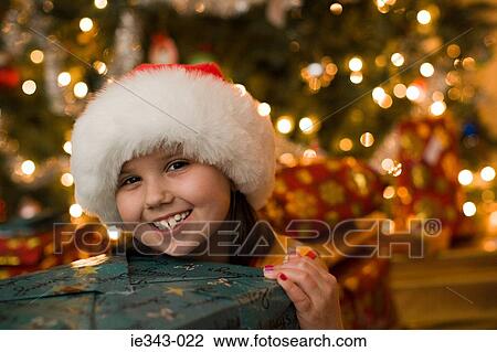 Girl with christmas gift View Large Photo Image Stock Image - Girl with christmas gift. Fotosearch