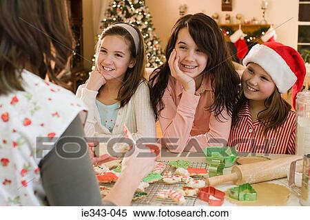 Girls and mother making cookies View Large Photo Image Stock Photography - Girls and mother making cookies. Fotosearch