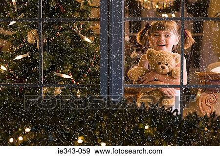 Little girl looking at snow View Large Photo Image Stock Photo - Little girl looking at snow. Fotosearch