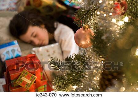 Sleeping girl and christmas gifts View Large Photo Image Stock Image - Sleeping girl and christmas gifts. Fotosearch