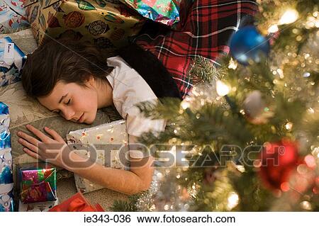 Sleeping girl and christmas gifts View Large Photo Image Stock Photograph - Sleeping girl and christmas gifts. Fotosearch