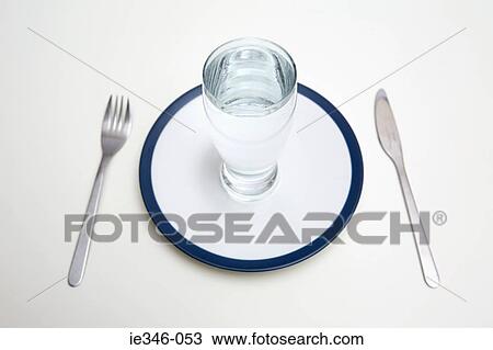 A glass of water on a plate View Large Photo Image Stock Image - A glass of water on a plate. Fotosearch