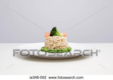 Brown rice and vegetables on a plate View Large Photo Image Stock Image - Brown rice and vegetables on a plate. Fotosearch