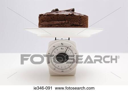 Chocolate cake on scales View Large Photo Image Stock Image - Chocolate cake on scales. Fotosearch