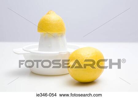 Picture - Lemons and a juicer. Fotosearch