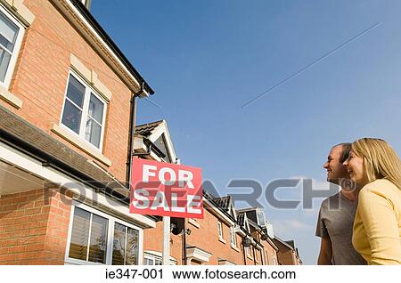 Couple looking at house for sale View Large Photo Image Stock Image - Couple looking at house for sale. Fotosearch